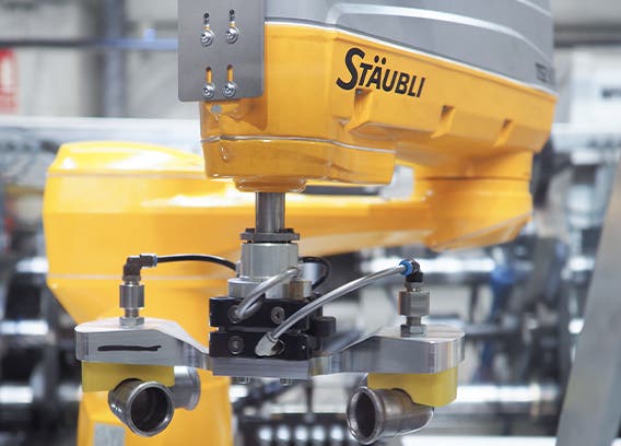 The SCARA robot handles the stainless steel pipe sections with its vacuum gripper.