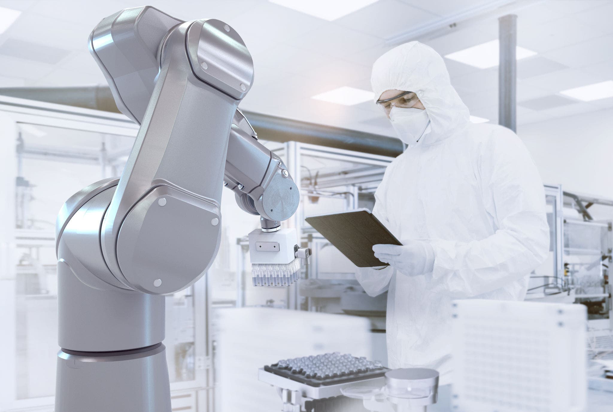 Quality Control Check: Scientist Using Digital Tablet Computer and wearing Protective Suit walks through Manufacturing Laboratory. Product Manufacturing: Pharmaceutics, Semiconductors, Biotechnology.