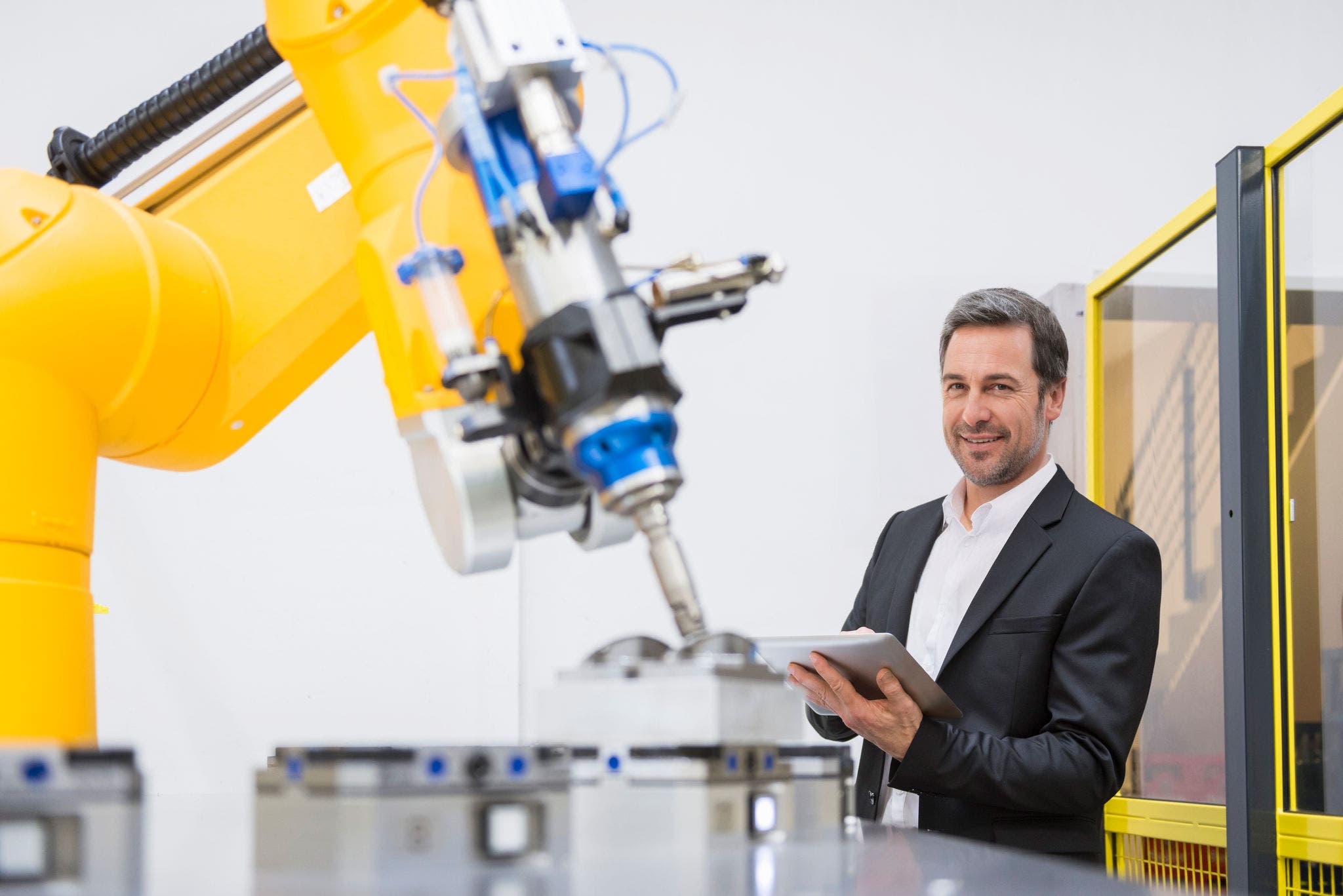 Businessman checking automated production in factory