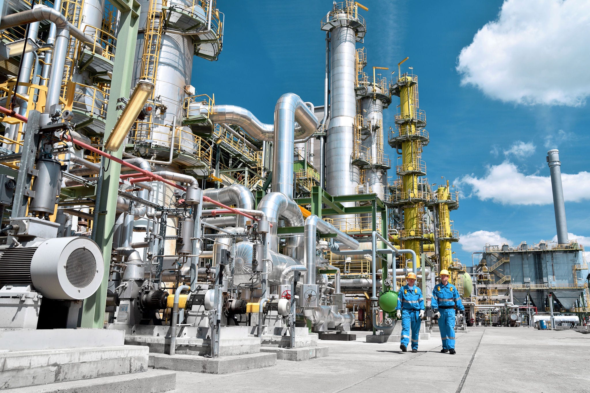chemical industry plant - workers in work clothes in a refinery with pipes and machinery ; Shutterstock ID 1801215094; purchase_order: Jasy DETAIL
