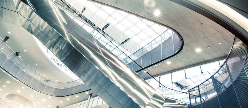 Key visual of Stäubli Corporate. A long passage at Zurich Airport, Switzerland. Image is used as header element for the Newsroom of the Stäubli group. It is edited with magic light effect, brand fresh-up filter and cut in header image size.