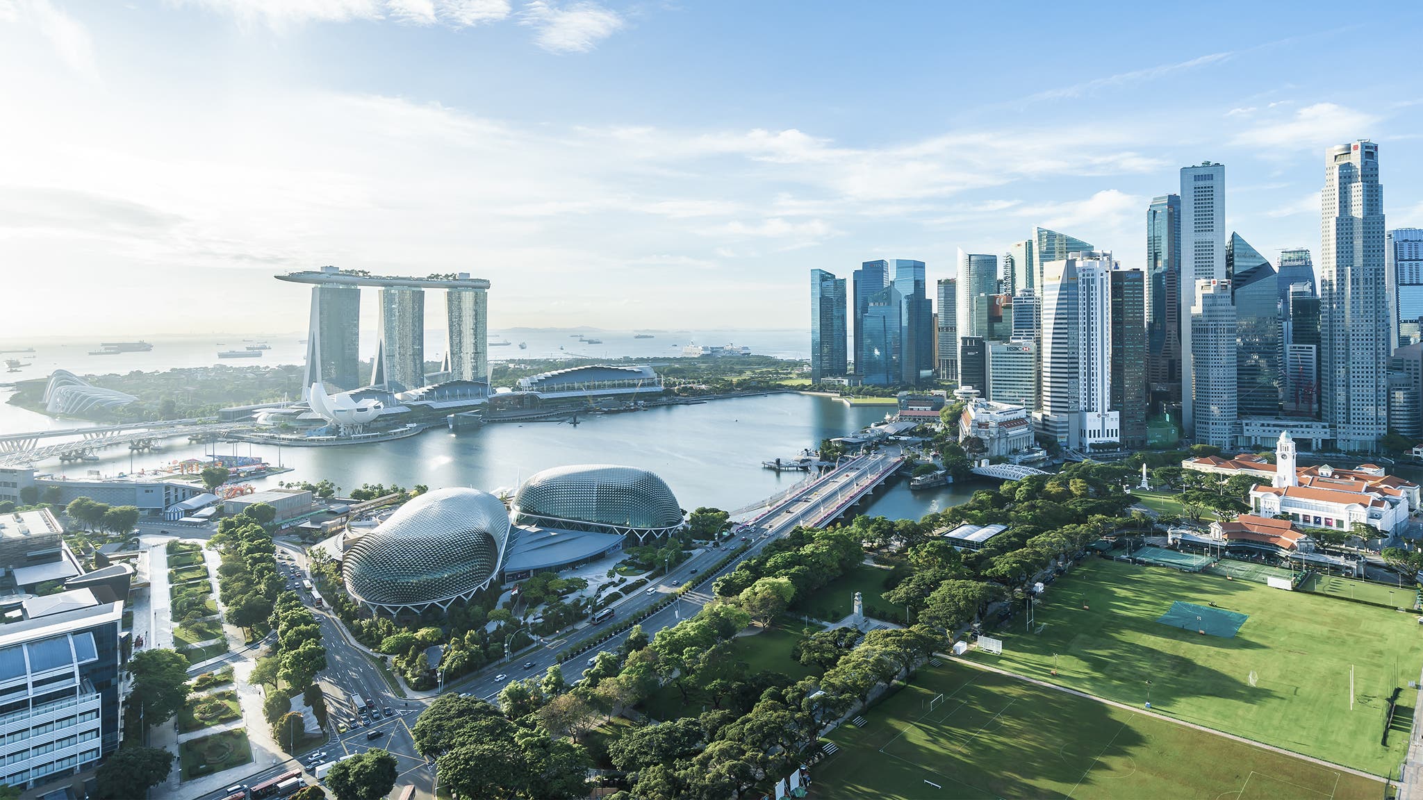 Beautiful architecture building exterior cityscape in Singapore city skyline with white cloud on blue sky