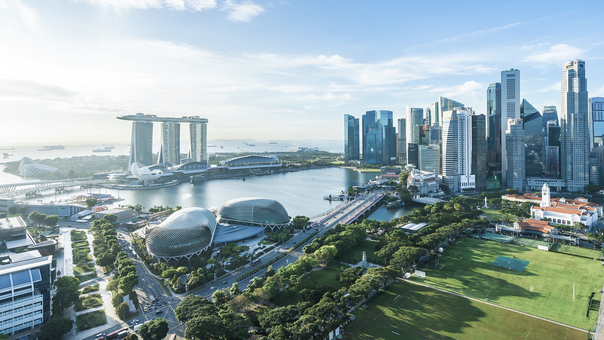 Beautiful architecture building exterior cityscape in Singapore city skyline with white cloud on blue sky