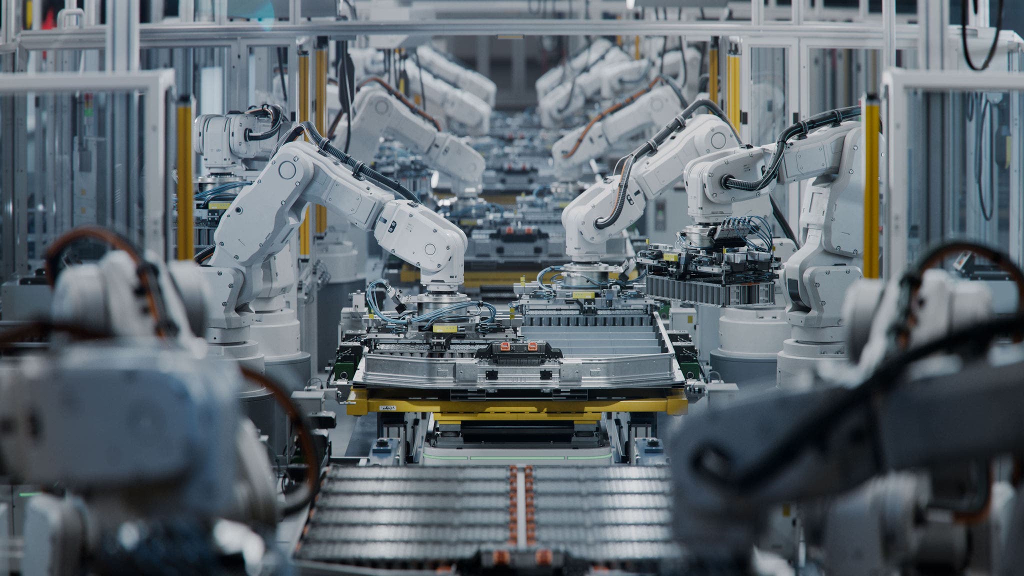 Robotic arms in a modern industrial manufacturing setting, assembling electronic components on a production line, showcasing automation technology.