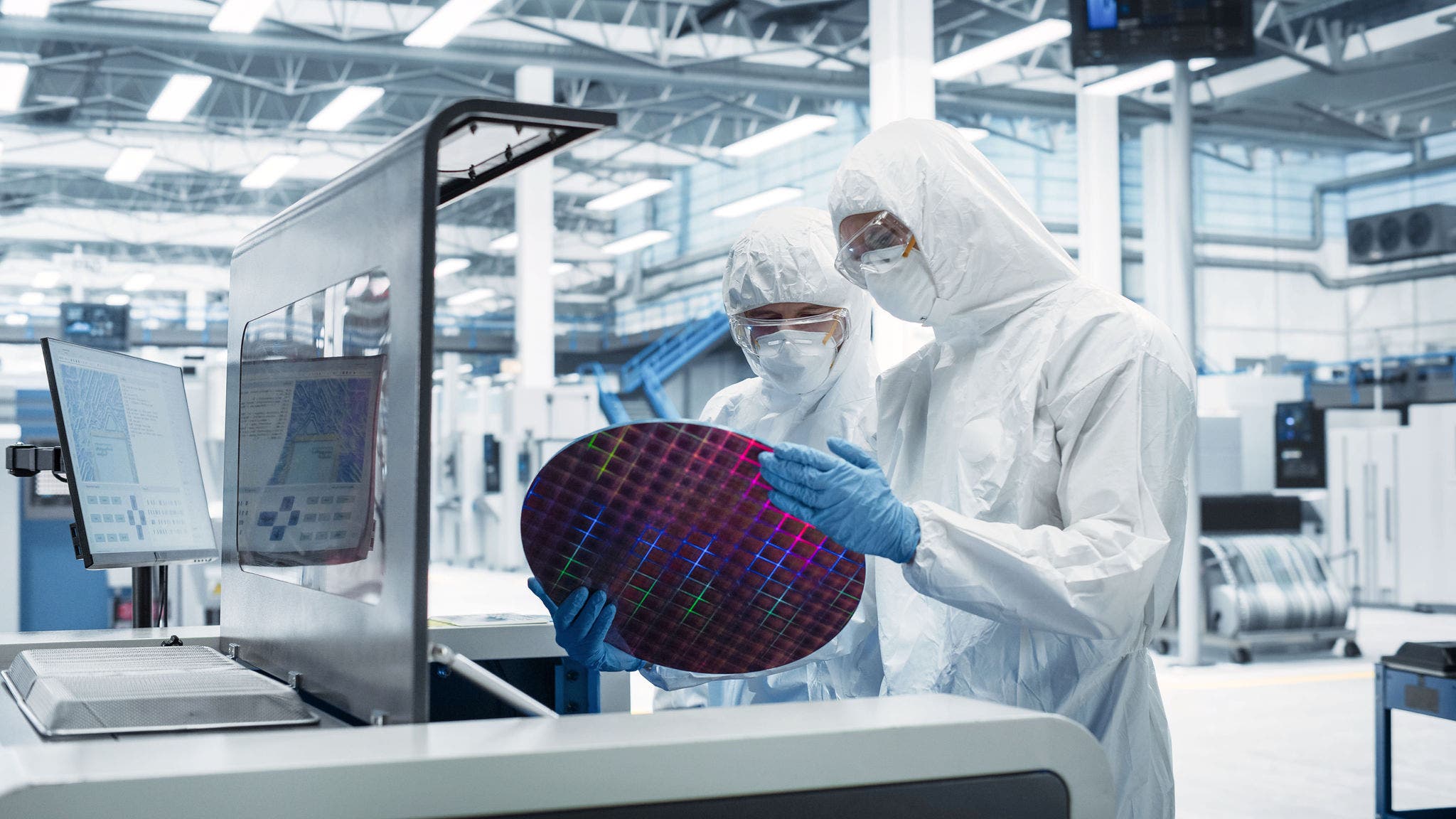 Semiconductor Production At Electronics Manufacturing Facility: Two Specialists In Sterile Suits Taking Out Silicon Wafer From Soldering Jet Printer And Checking It. Engineers Making Computer Hardware; Shutterstock ID 2557731301; purchase_order: Jasmin Zehnder