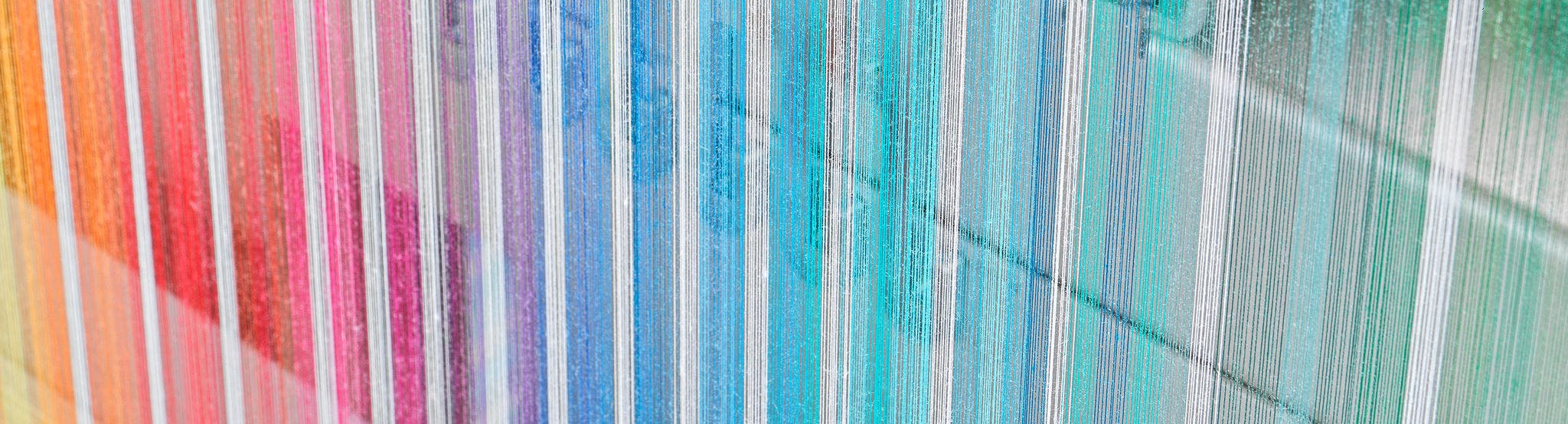Zoom on BEAMPRO reading in machine sorting coloured warp sheets at the sizing machine.