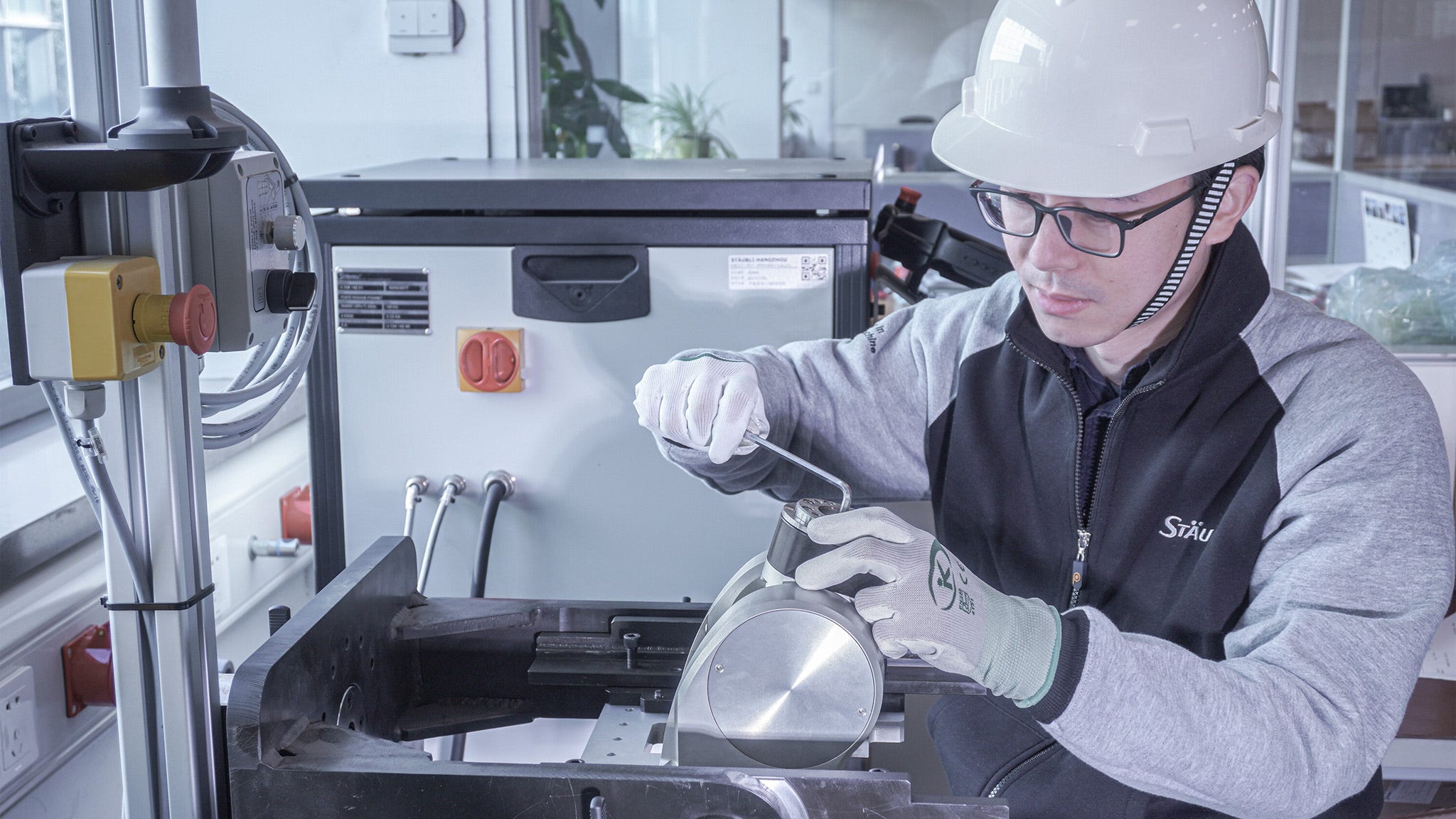 Maintenance technician operating on a TX2-90 wrist.