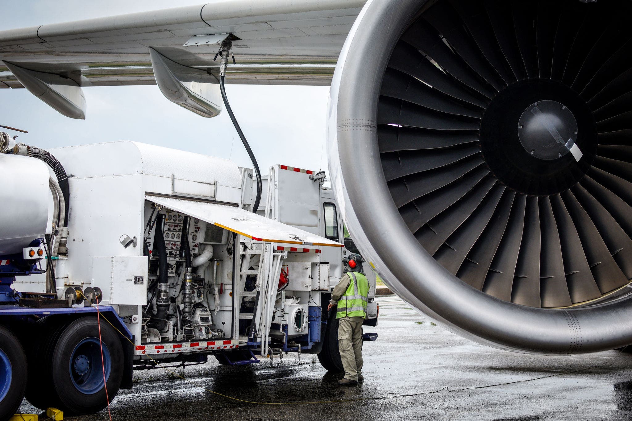 Aircraft refueling by high pressure fuel supply truck.Passenger jet airplane refuel from supply truck, airport service, refuel,Aircraft Refueling Hose.; Shutterstock ID 1258252366; purchase_order: Jasy DETAIL