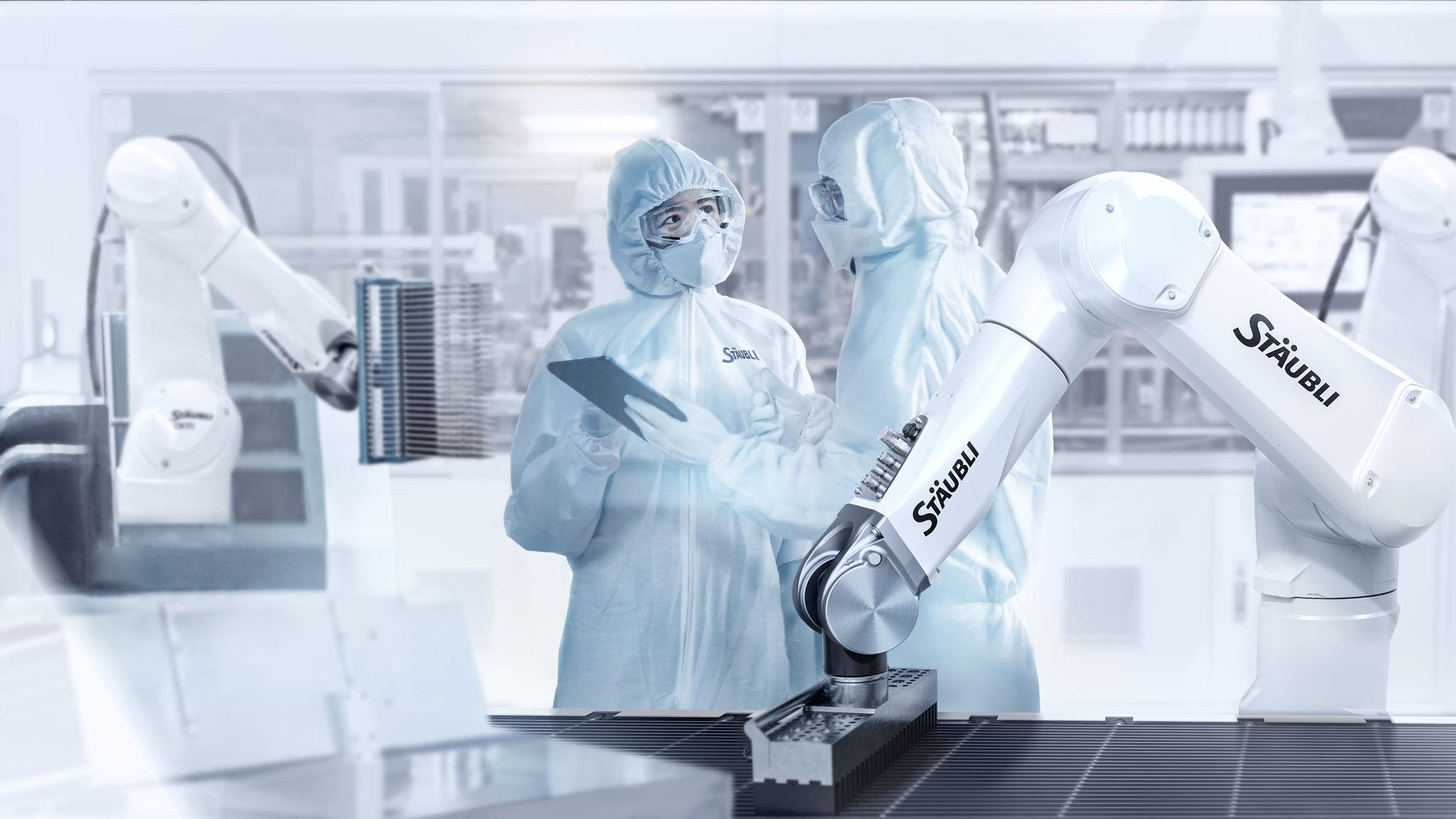 Factory Cleanroom: Engineer and Scientist Wearing Coveralls, Standing in Workshop Talk and Use Tablet Computer, Professionals Develop Technology for Modern CNC Machinery and Electronic Equipment