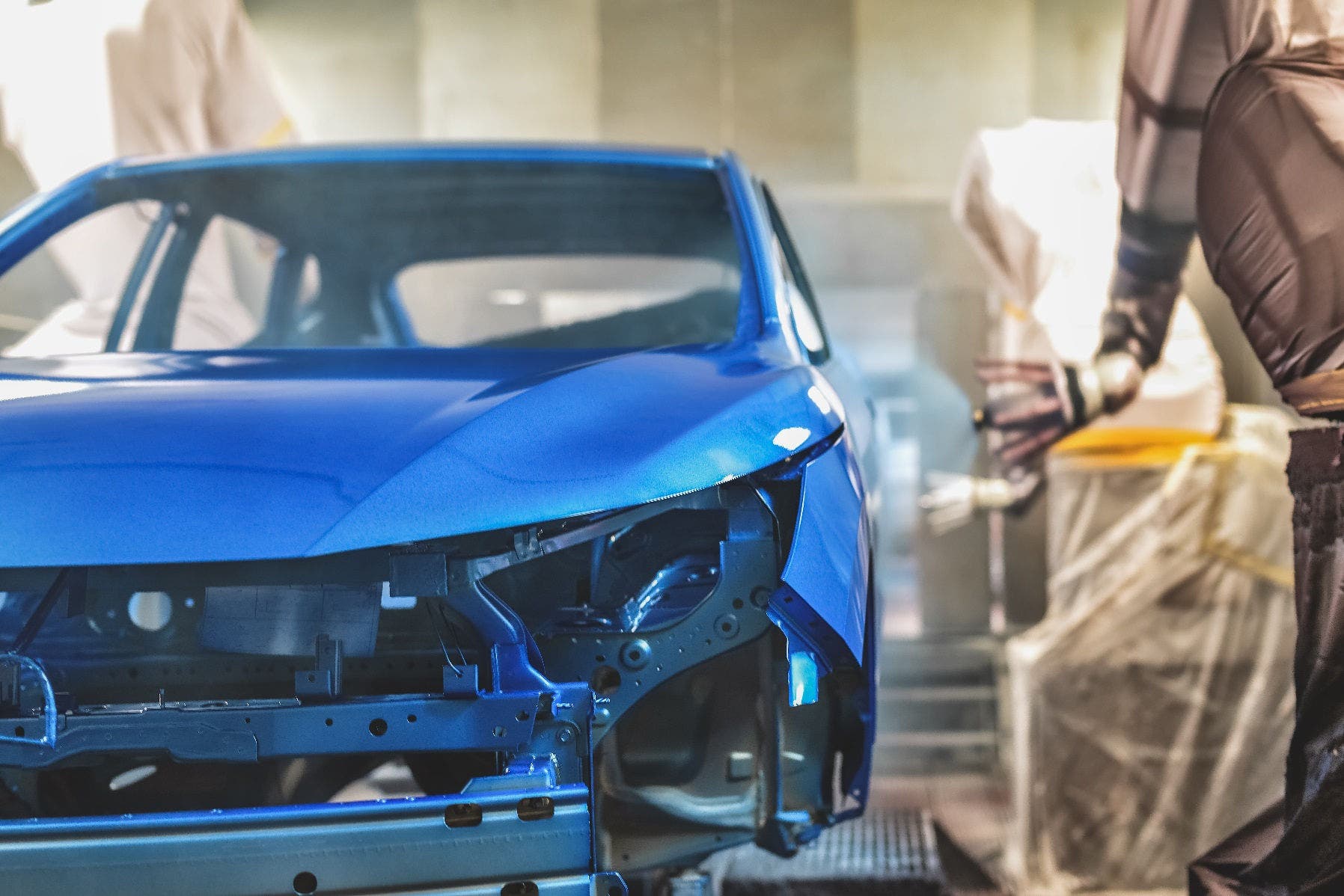 Production line of automobile plant, paint shop. Car body after applying the base paint.