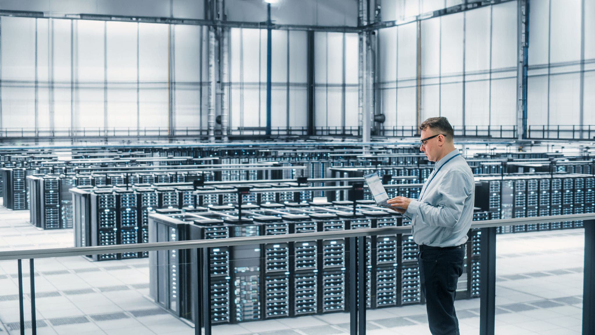 Data Center Engineer Using Laptop Computer. Server Farm Cloud Computing Specialist Facility with Adult Male System Administrator Working with Data Protection Network for Cyber Security.; Shutterstock ID 2052013328; purchase_order: Jasmin Zehnder