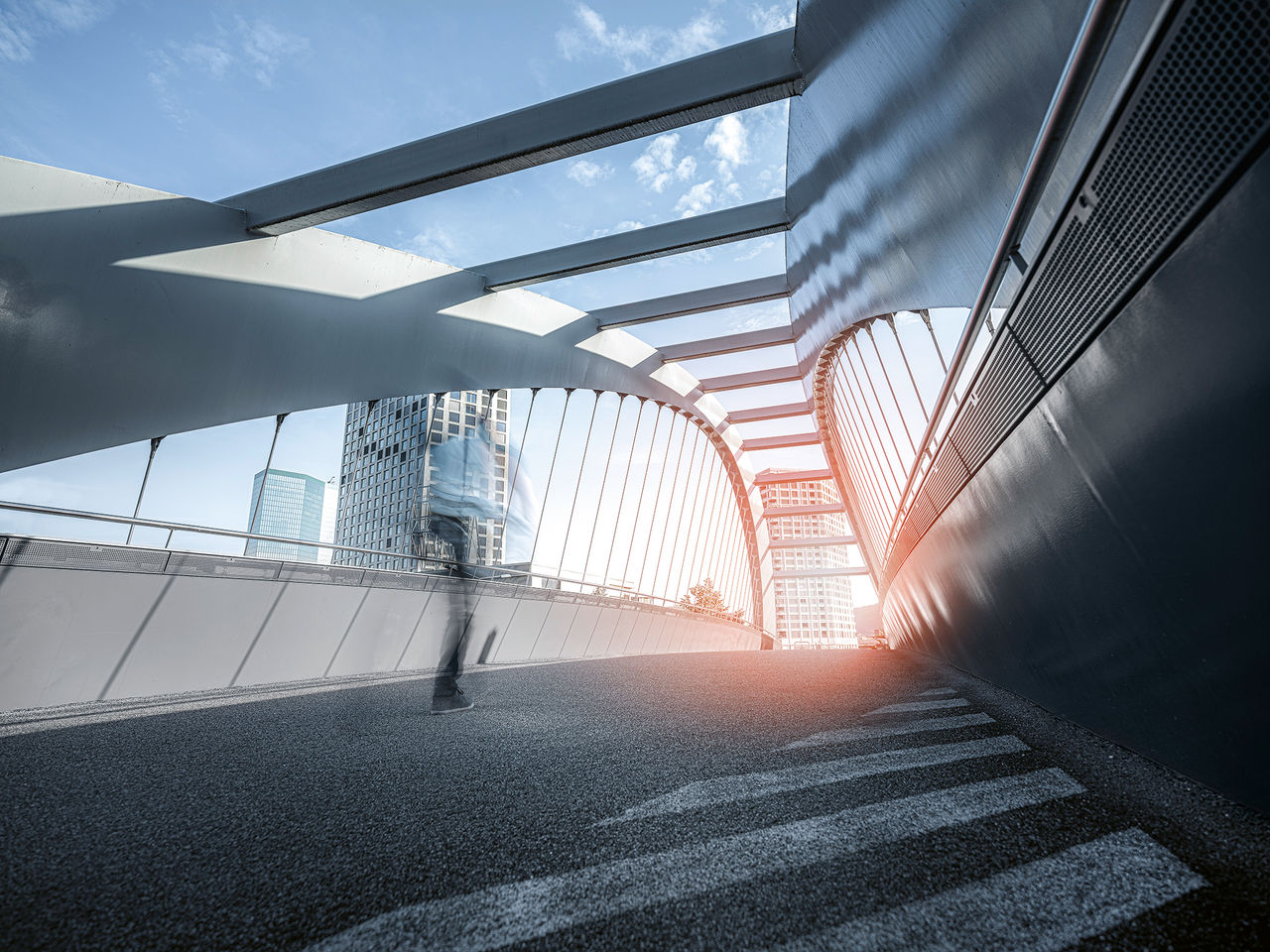 Key visual showing the bridge “Gleisbogen” in Zurich, Switzerland, with one person in movement. Edited with brand fresh-up filter and magic light effect.