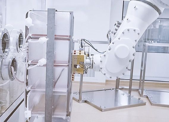 The camera-controlled robot docks onto the “cell factories”, each of which contains 160 trays of vaccine.