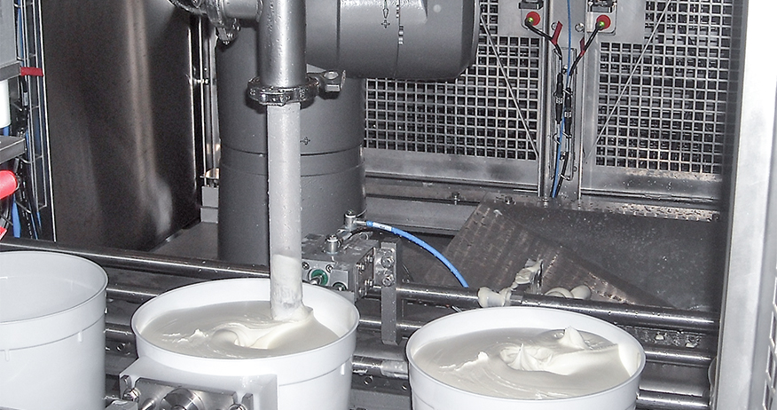 The robot is seen here filling a tub with ice cream.